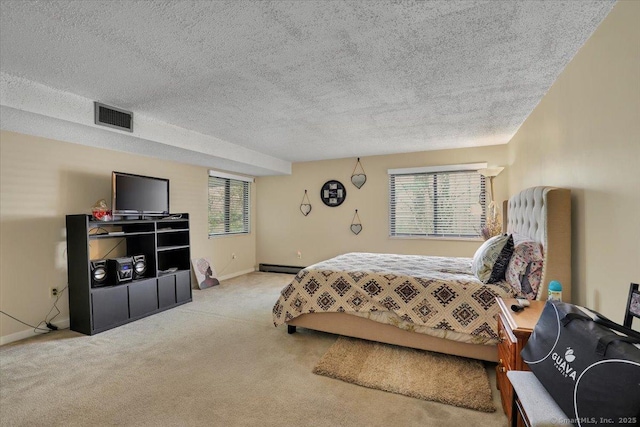 bedroom with visible vents, carpet flooring, a baseboard radiator, and multiple windows