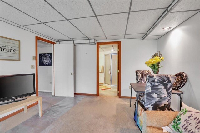 interior space featuring baseboards, carpet, and a paneled ceiling