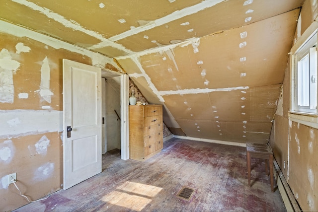interior space with visible vents, lofted ceiling, and hardwood / wood-style floors