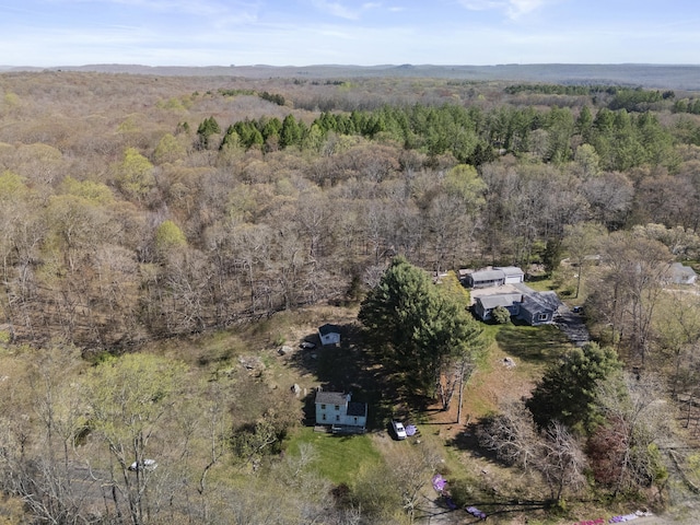 drone / aerial view with a wooded view