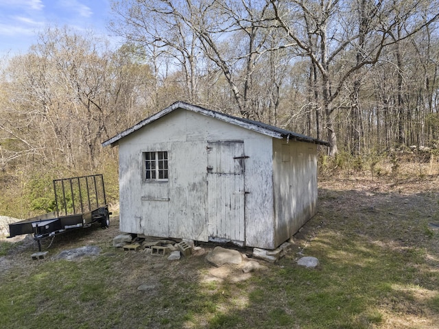 view of shed with a wooded view