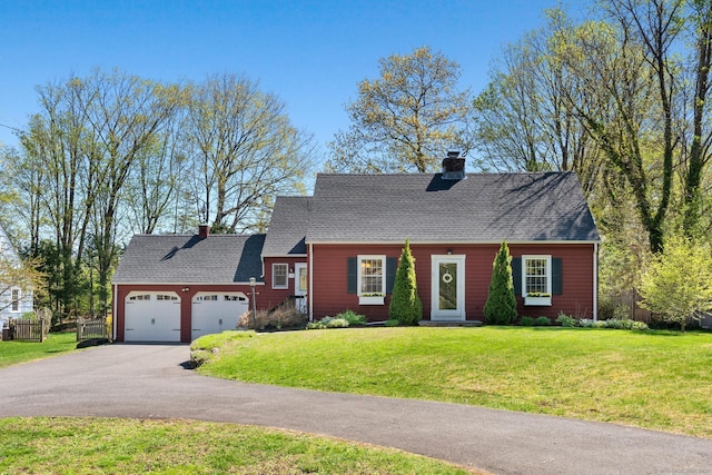 cape cod house with driveway, a chimney, a garage, fence, and a front lawn