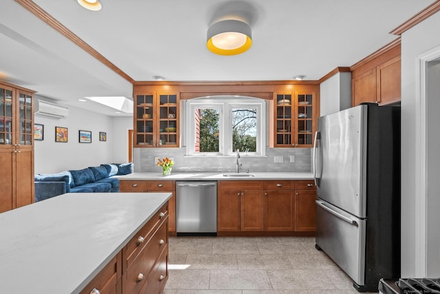 kitchen featuring a sink, appliances with stainless steel finishes, a wall mounted air conditioner, and light countertops