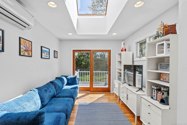living area featuring recessed lighting, a skylight, a wall mounted AC, and light wood-type flooring