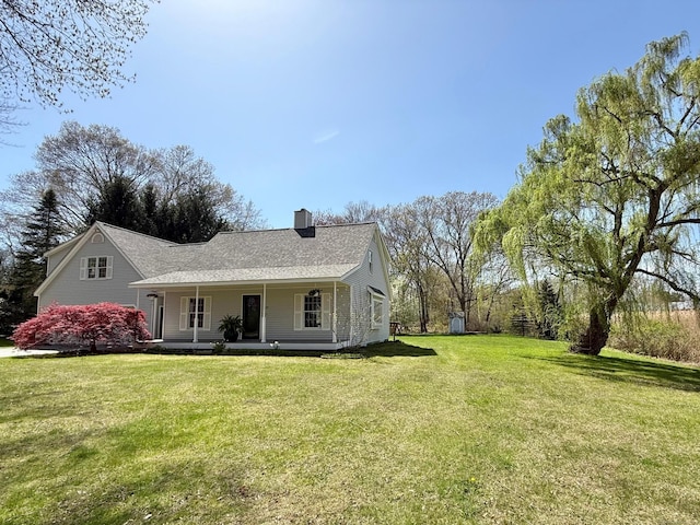 exterior space with a porch, a chimney, and a front lawn