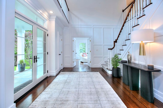 9 November Trl, Weston, CT 06883 - entrance foyer featuring a decorative wall, stairway, dark wood finished floors, french doors, and ornamental molding