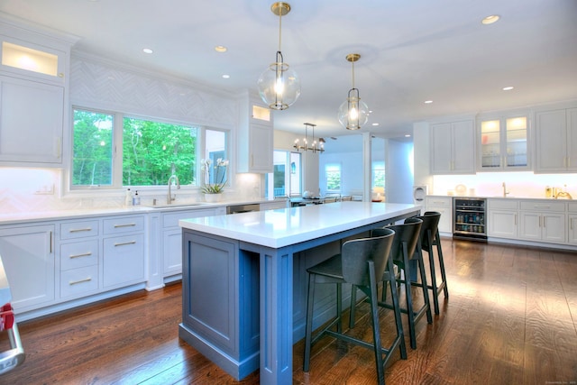 9 November Trl, Weston, CT 06883 - kitchen with beverage cooler, a sink, white cabinetry, a kitchen island, and dark wood-style flooring