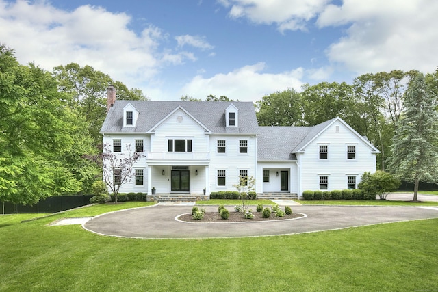 9 November Trl, Weston, CT 06883 - view of front of house featuring curved driveway, a chimney, and a front lawn