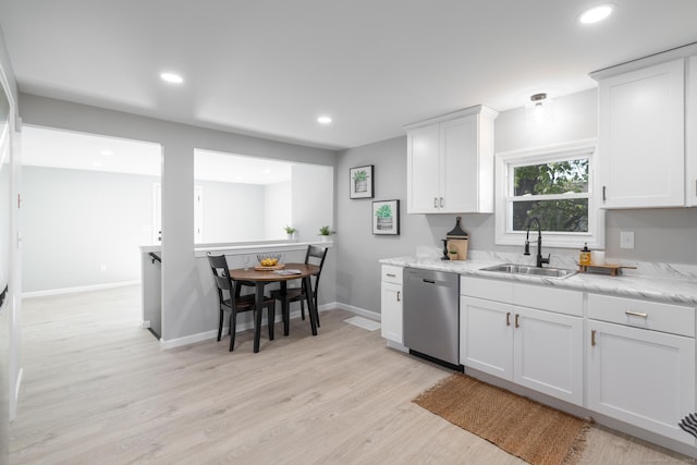 kitchen with stainless steel dishwasher, a sink, baseboards, light wood-style floors, and recessed lighting