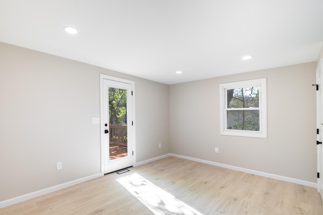 foyer with light wood-style floors, baseboards, and a healthy amount of sunlight