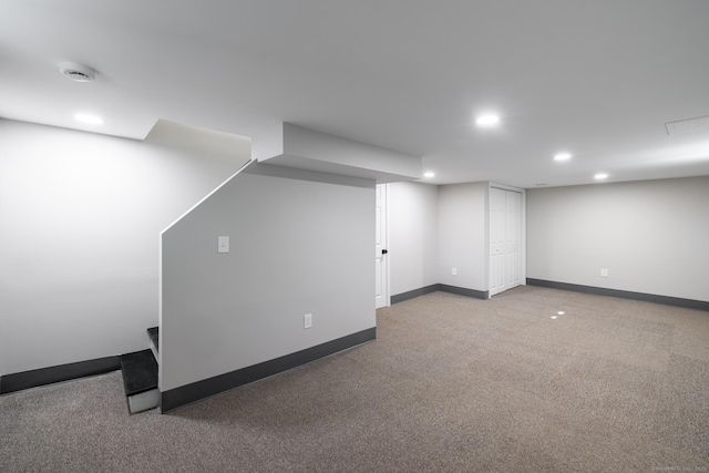 finished below grade area with baseboards, carpet flooring, and recessed lighting