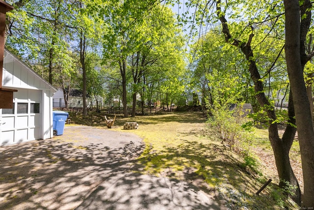view of yard with aphalt driveway