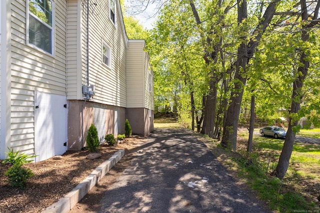 view of side of property with aphalt driveway