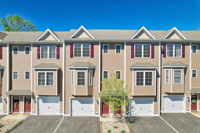 view of property featuring an attached garage and driveway