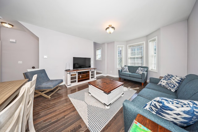 living area featuring baseboards and dark wood finished floors