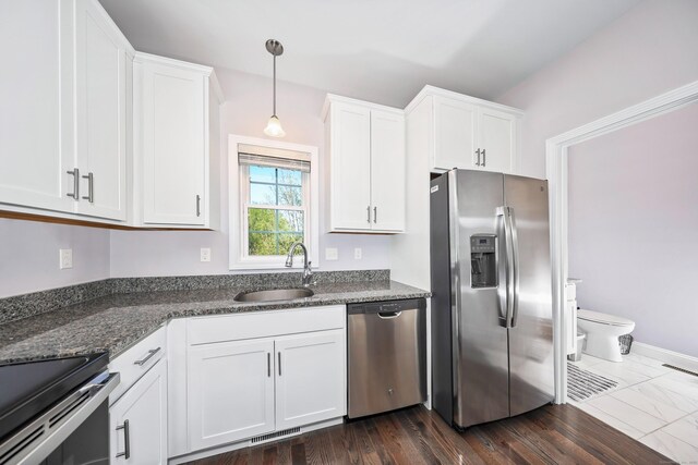 kitchen featuring a sink, stainless steel appliances, white cabinetry, and visible vents
