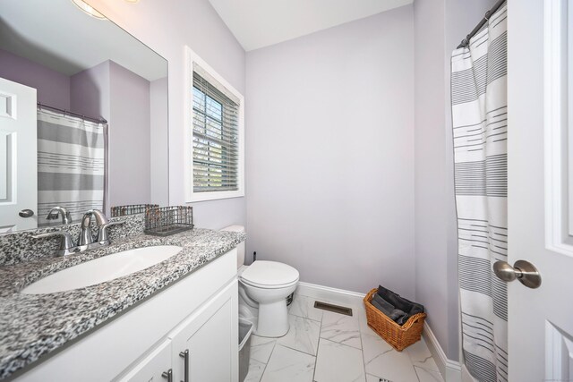 bathroom featuring vanity, baseboards, toilet, and marble finish floor