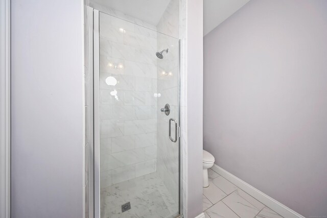 full bathroom with toilet, baseboards, marble finish floor, and a stall shower