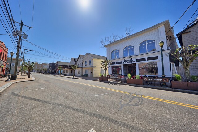 view of street featuring sidewalks, curbs, and street lights