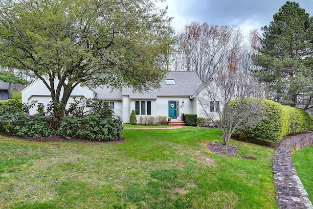 view of front of house featuring a shingled roof and a front lawn