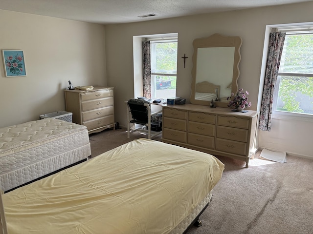 bedroom featuring baseboards, visible vents, and dark carpet