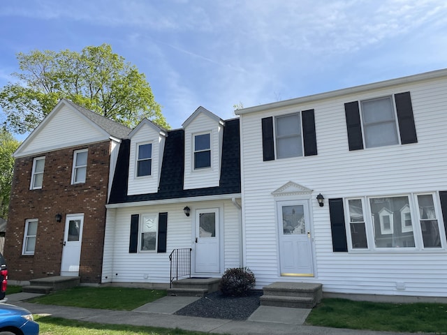 view of front of property featuring roof with shingles