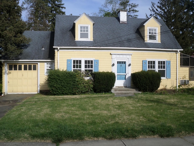 new england style home featuring a garage, a chimney, driveway, and a front lawn