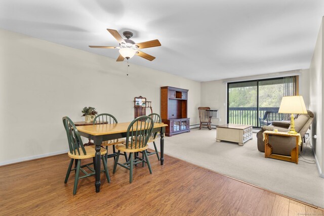 dining space featuring baseboards, ceiling fan, and wood finished floors