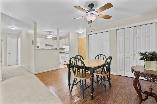 dining space with baseboards, ceiling fan, and wood finished floors