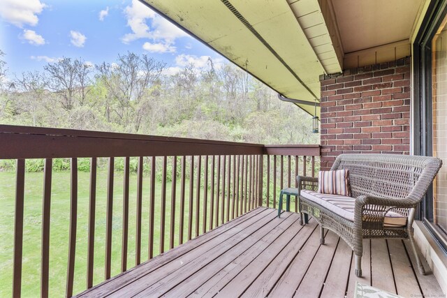 wooden deck featuring a yard