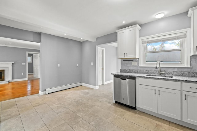 kitchen featuring backsplash, dishwasher, a sink, and a baseboard radiator