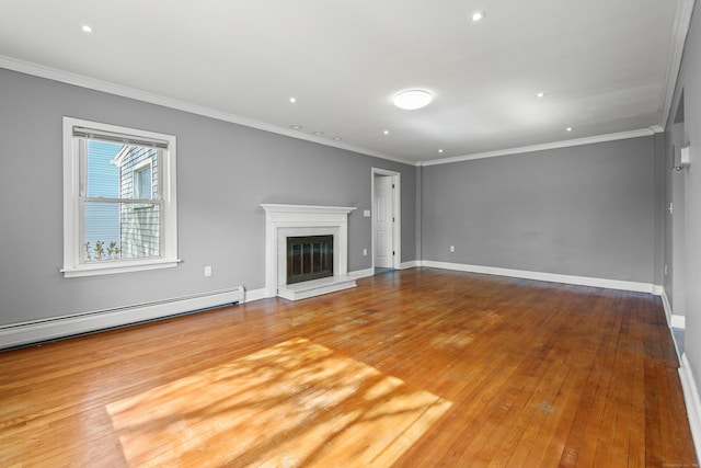 unfurnished living room featuring crown molding, a glass covered fireplace, baseboards, wood finished floors, and a baseboard heating unit