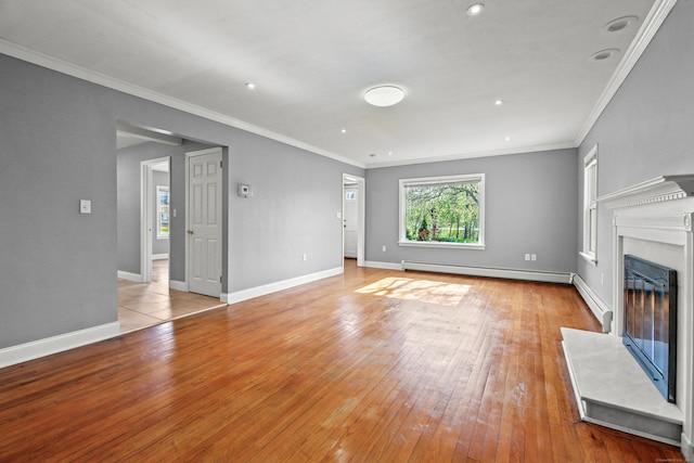 unfurnished living room featuring light wood-style floors, baseboards, baseboard heating, and a fireplace