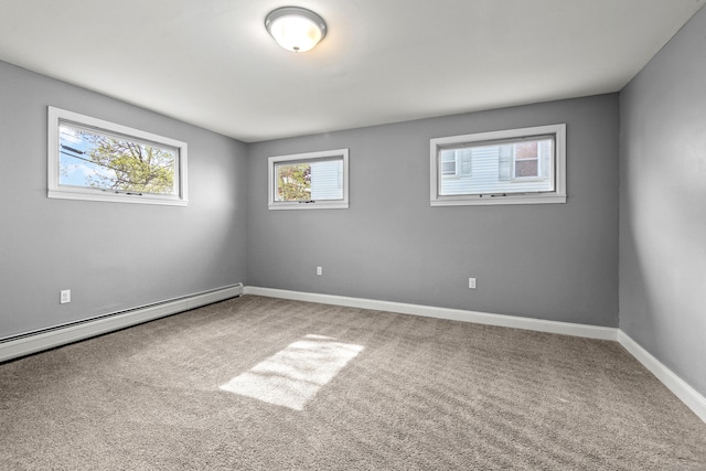 carpeted empty room featuring baseboards and a baseboard radiator