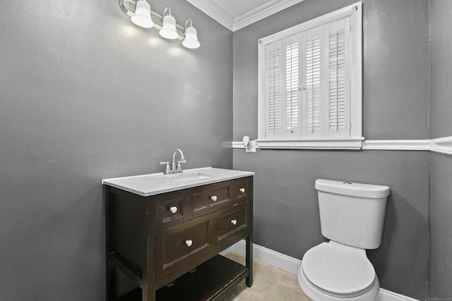 bathroom with crown molding, baseboards, vanity, and toilet