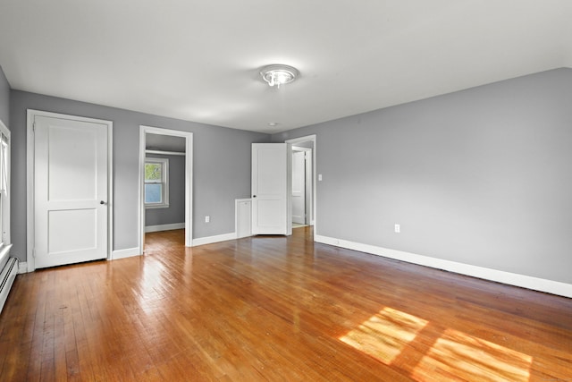 unfurnished bedroom with baseboards and wood finished floors