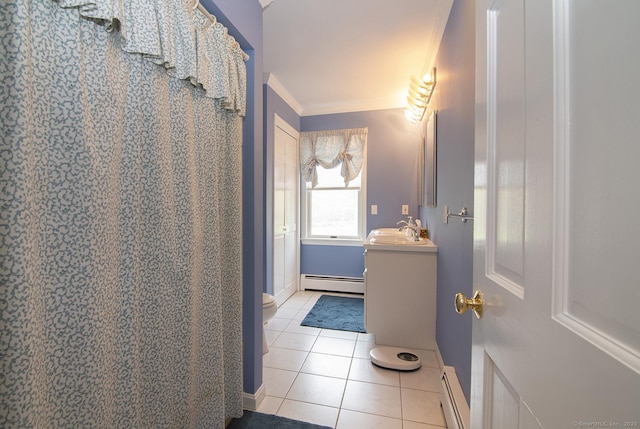bathroom with a baseboard heating unit, baseboards, tile patterned floors, and vanity