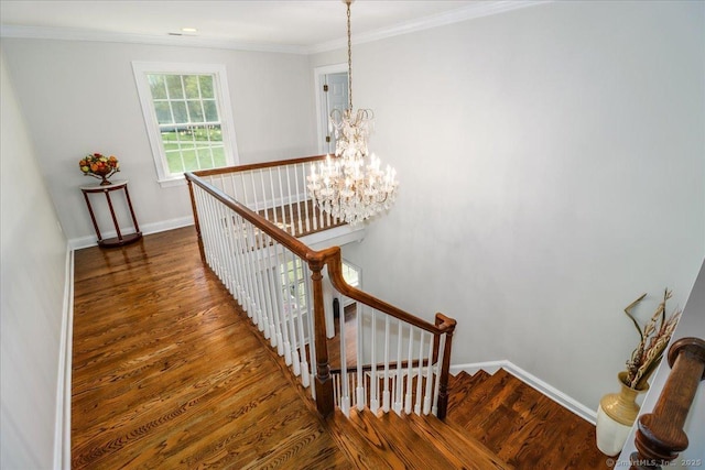 stairway with crown molding, baseboards, wood finished floors, and a chandelier