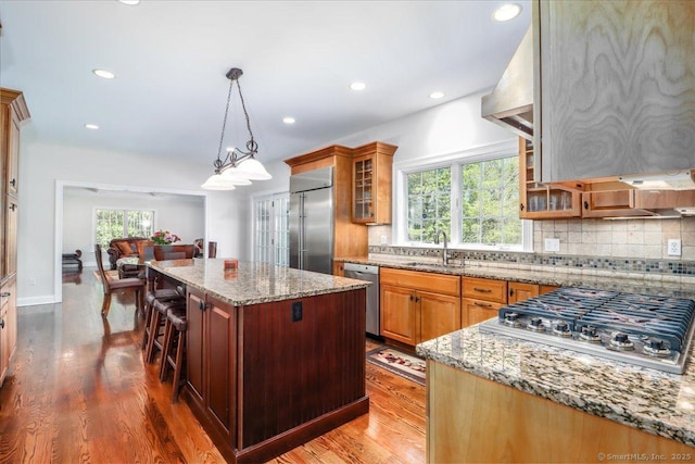 6 E Starrs Plain Rd, Danbury, CT 06810 - kitchen with appliances with stainless steel finishes, a sink, backsplash, a center island, and light stone countertops