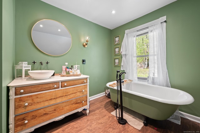 10 Gilmour St, Norwich, CT 06360 - bathroom featuring baseboards, a freestanding tub, wood finished floors, and vanity