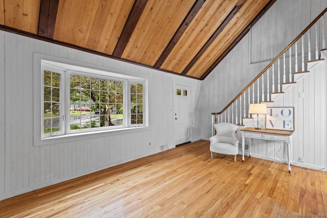 entryway with hardwood / wood-style flooring, stairway, wood walls, and wooden ceiling