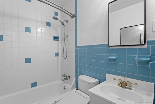 full bathroom featuring shower / bath combination, toilet, tile walls, and vanity