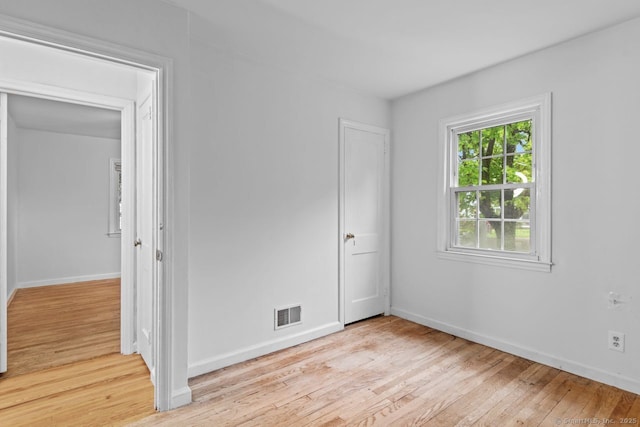 unfurnished bedroom with light wood finished floors and baseboards