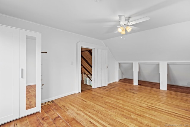additional living space with ceiling fan, lofted ceiling, light wood-style floors, and baseboards