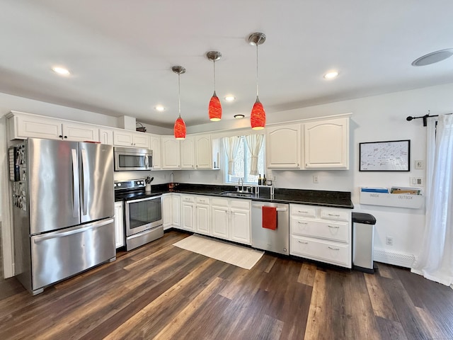 33 Steep Hill Rd, Seymour, CT 06483 - kitchen with appliances with stainless steel finishes, dark countertops, a sink, dark wood finished floors, and recessed lighting