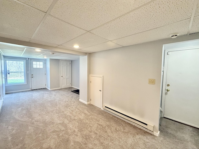 33 Steep Hill Rd, Seymour, CT 06483 - basement featuring a baseboard heating unit, a paneled ceiling, carpet floors, and baseboards