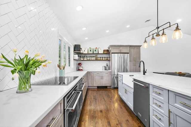 kitchen featuring backsplash, appliances with stainless steel finishes, open shelves, a sink, and lofted ceiling