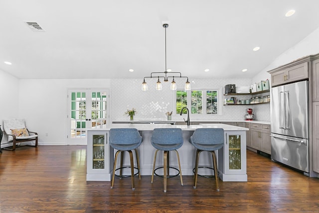 kitchen with visible vents, light countertops, tasteful backsplash, french doors, and high end refrigerator