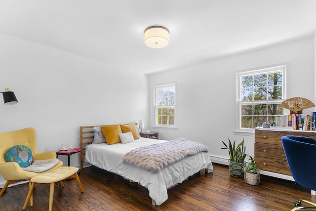 bedroom featuring dark wood-type flooring and a baseboard radiator