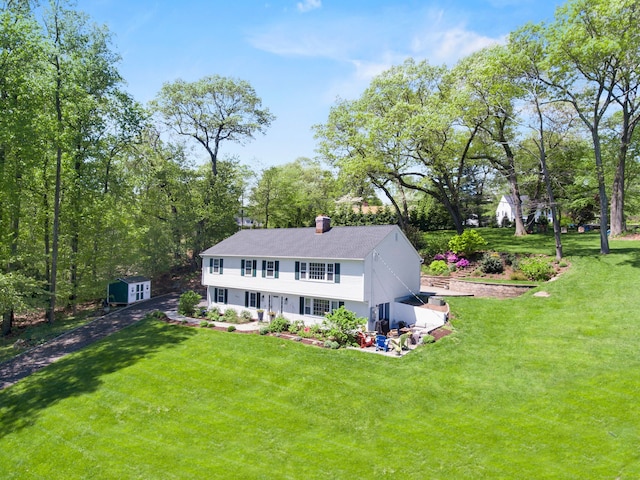 95 Brighton View Rd, Fairfield, CT 06824 - view of front of home featuring a front lawn, a chimney, and a patio area